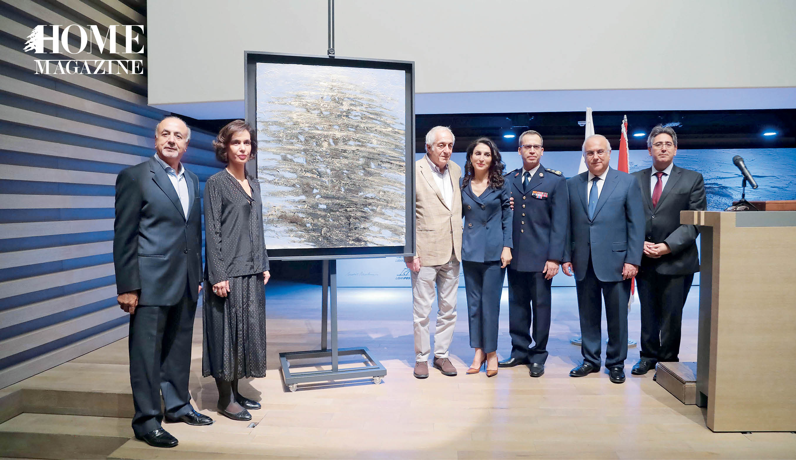 Men and women standing next to a painting