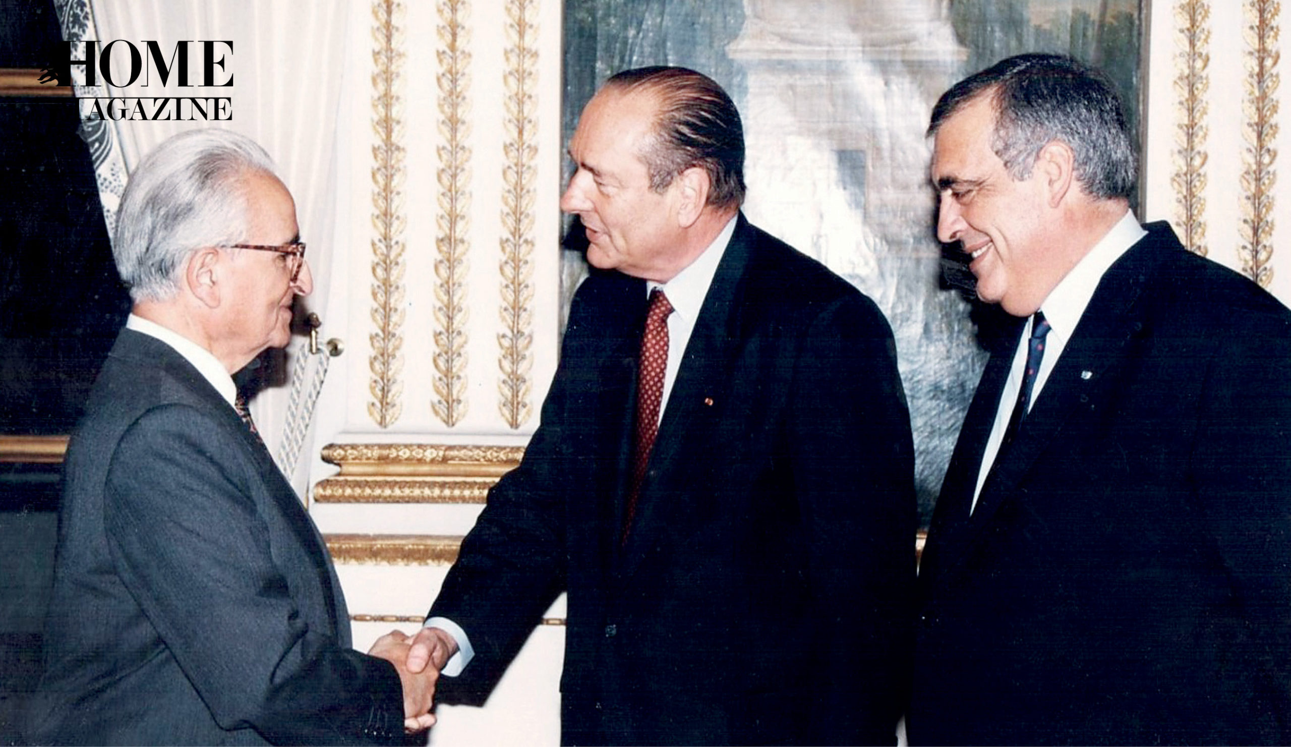 Three men in suits shaking hands