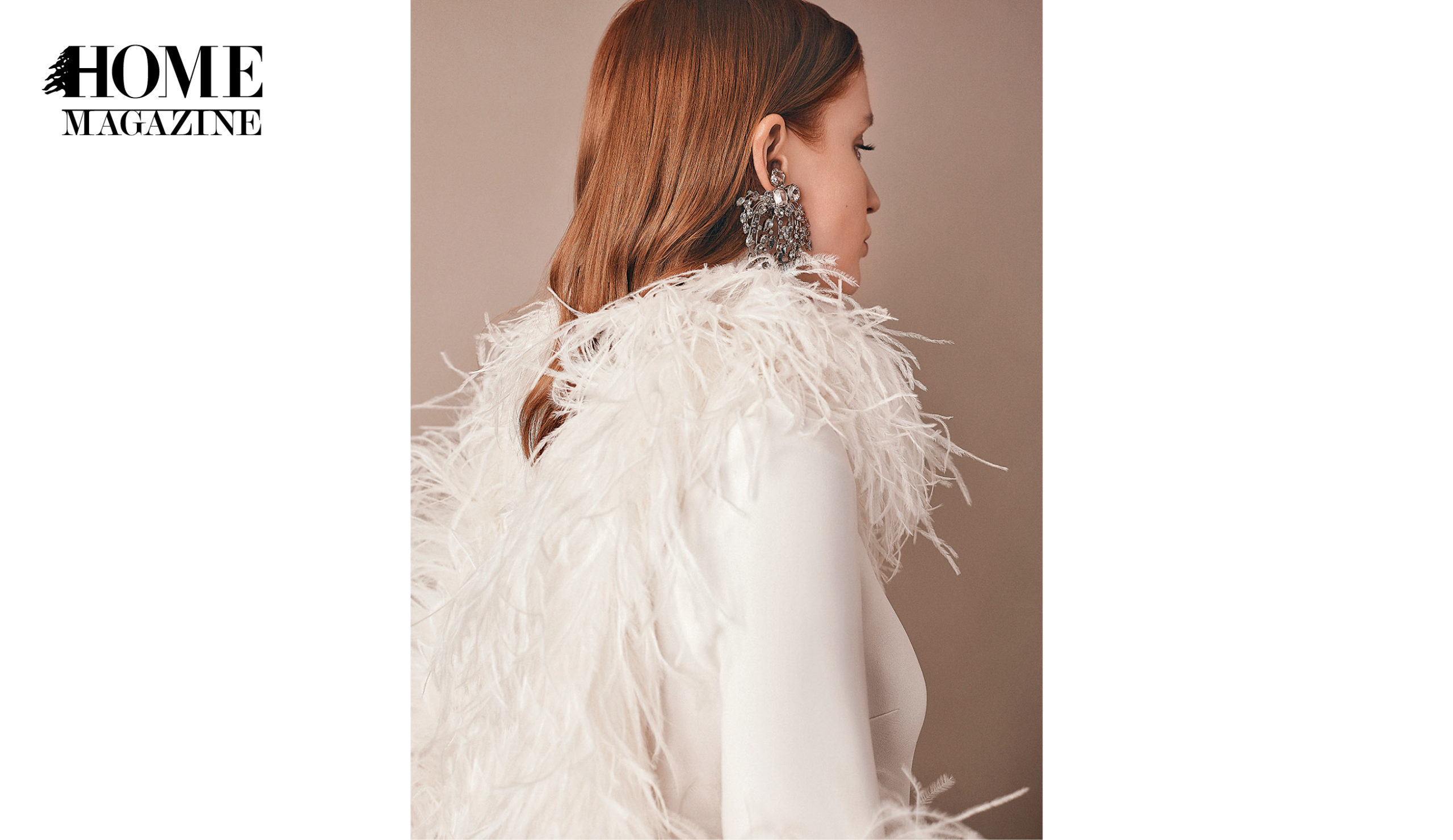 Profile of a model wearing big silver earing and a white blouse with feathers