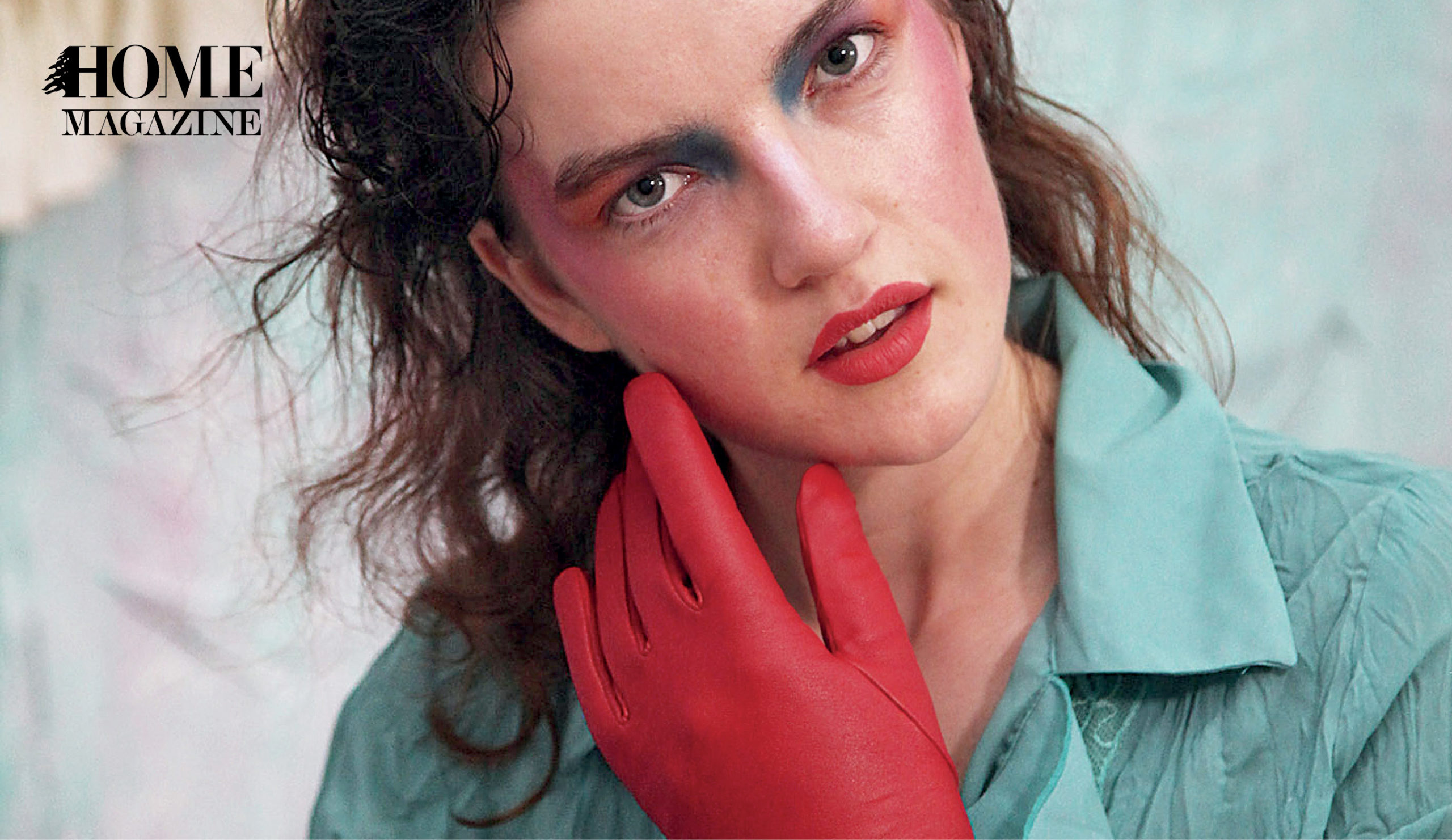 Face portrait of a woman with makeup, a red glove and a blue shirt