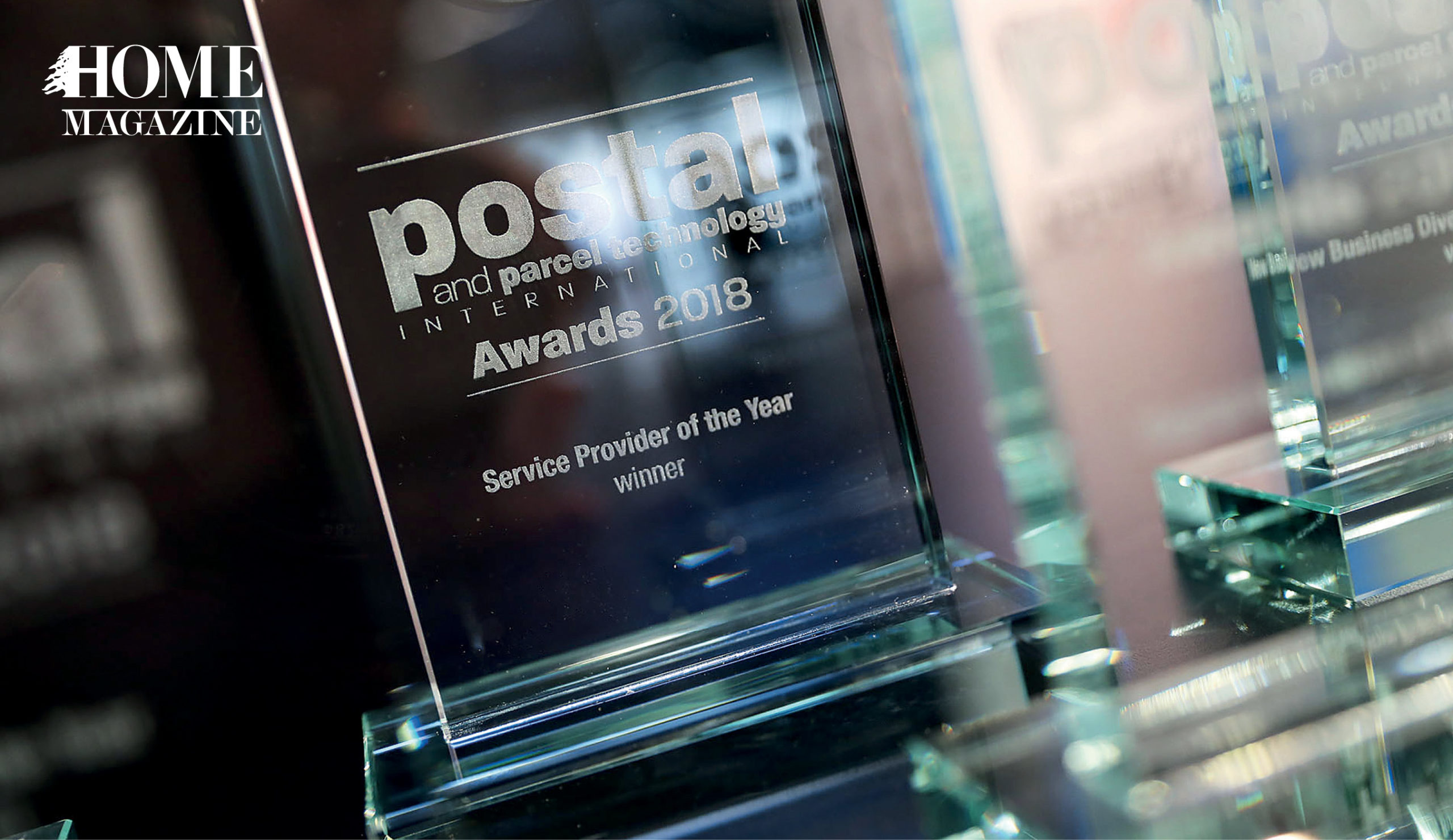 Glass trophy with text postal awards 2018 service provider of the year winner